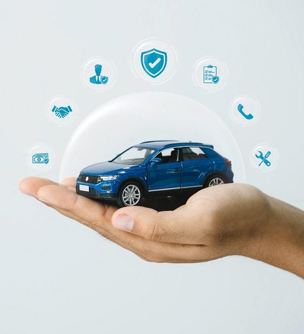 A car in a person's hand with icons representing warranty and protection.